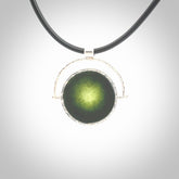 A photo of a New Zealand Jade drop pendant with sterling silver. This is a stylish statement piece - hand crafted here in New Zealand by Ana Krakosky. Unique Art to Wear. Gifts for all lovers of hand made Art to Wear. One only Fidget pendant.